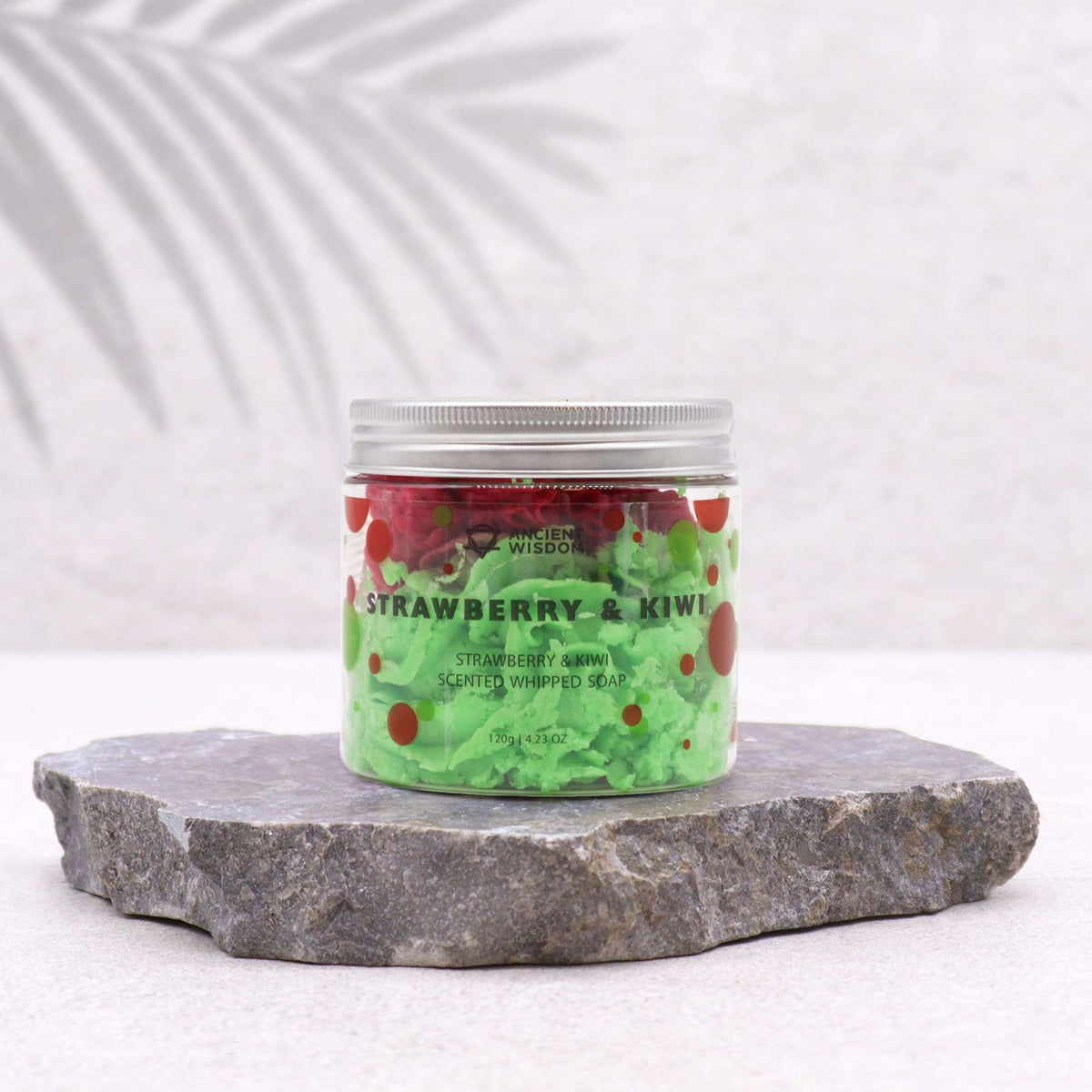 Jar of Strawberry Kiwi Whipped Soap on a stone platform with a white background