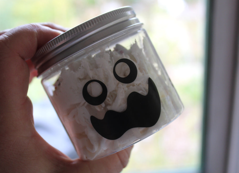 Whipped soap pot with spooky face on white background
