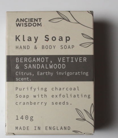 A rectangular box of Ancient Wisdom Klay Soap Hand & Body Soap, featuring a beige and dark gray color scheme with botanical line drawings. The box details the scent as Bergamot, Vetiver & Sandalwood and lists key ingredients and product details.