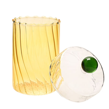 Yellow Glass Trinket Box and matching lid  with green knob on a white background