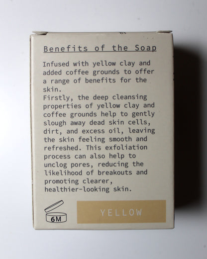 The back of a beige soap box showing product details, including a text section titled 'Benefits of the Soap' and a yellow label at the bottom indicating 'YELLOW' and '6M'.