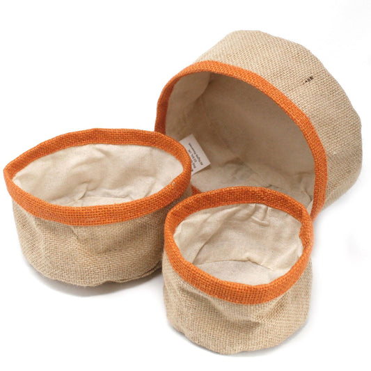 Three beige fabric bowls with orange rims on a white background