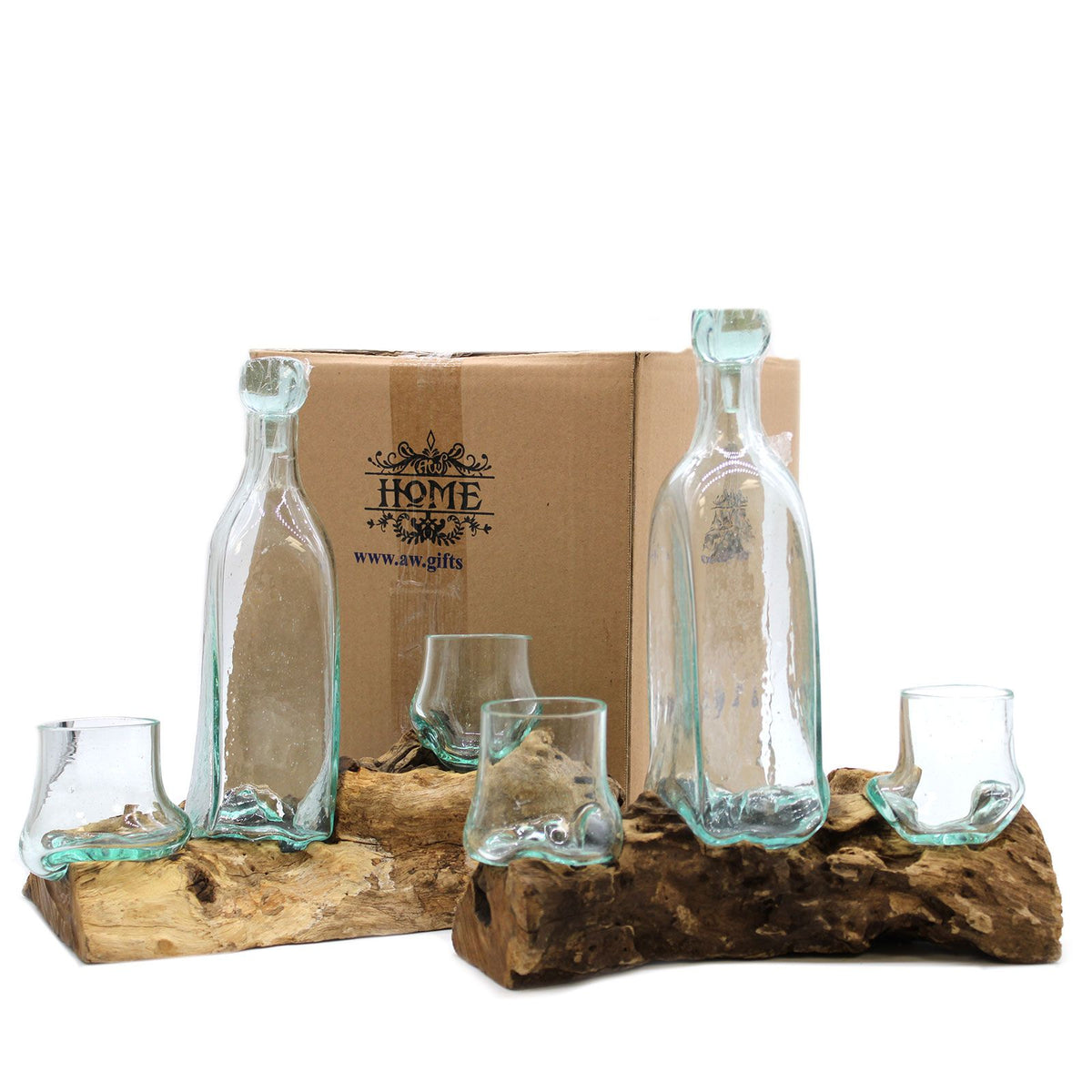 Set of glass bottles and glasses on a wooden stand with a cardboard box in the background.