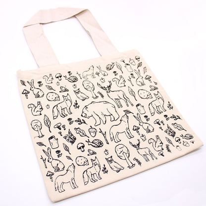 Tote bag with black animal illustrations on a white background