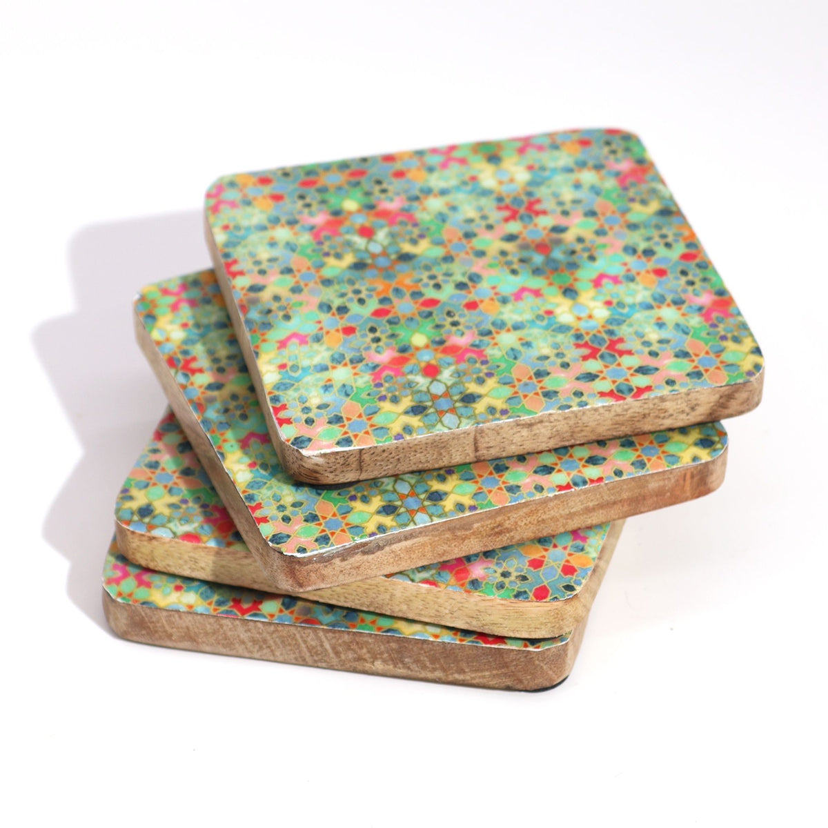 Set of four colorful square handcrafted wooden coasters on a white background