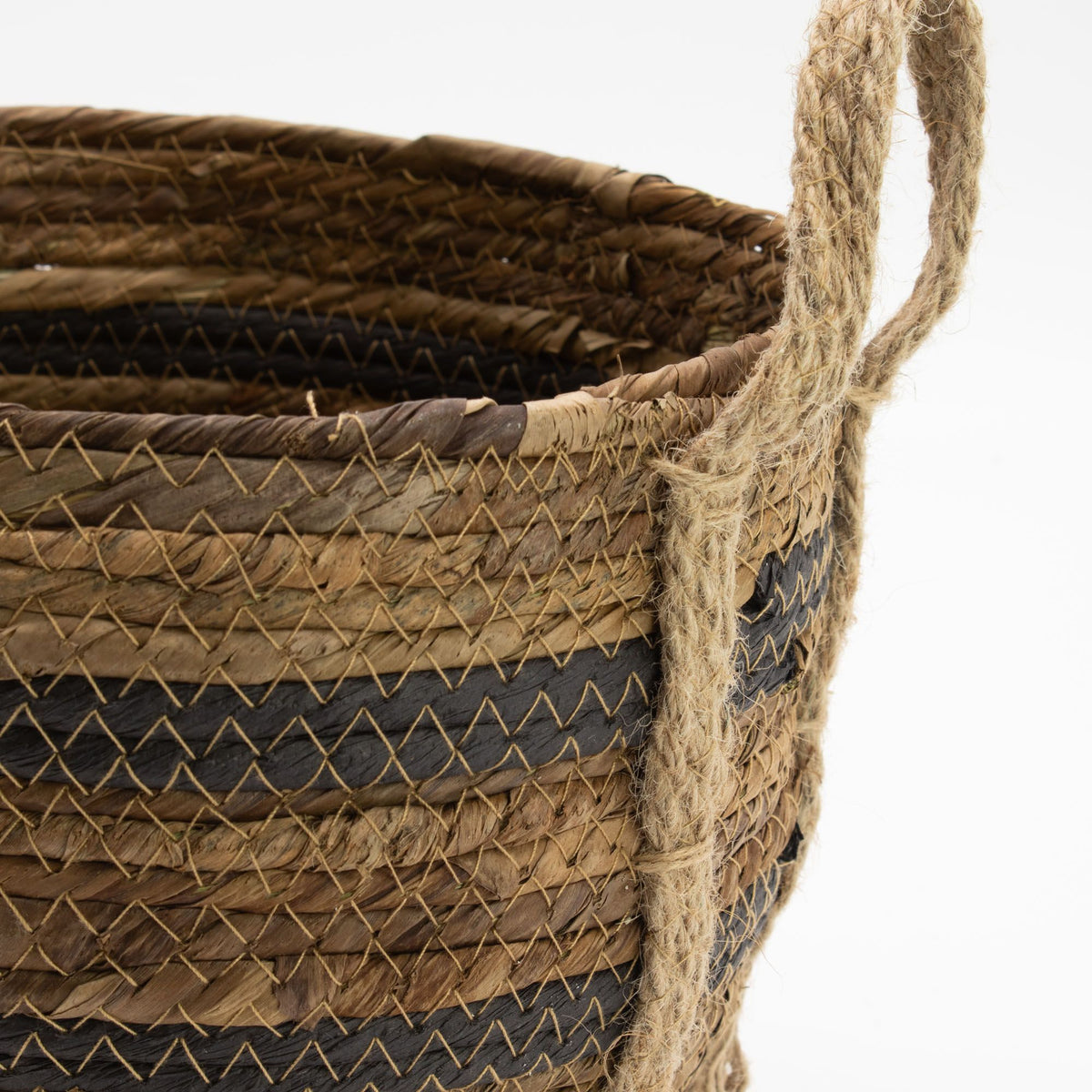 Close-up of a woven basket with a handle on a white background
