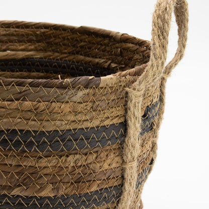 Close-up of a woven basket with a handle on a white background