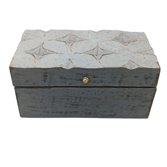 Decorative wooden box with star patterns on a white background