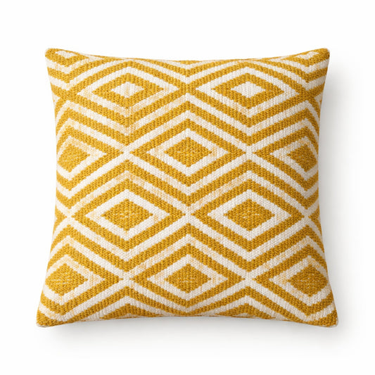 Yellow and white geometric patterned pillow on a white background