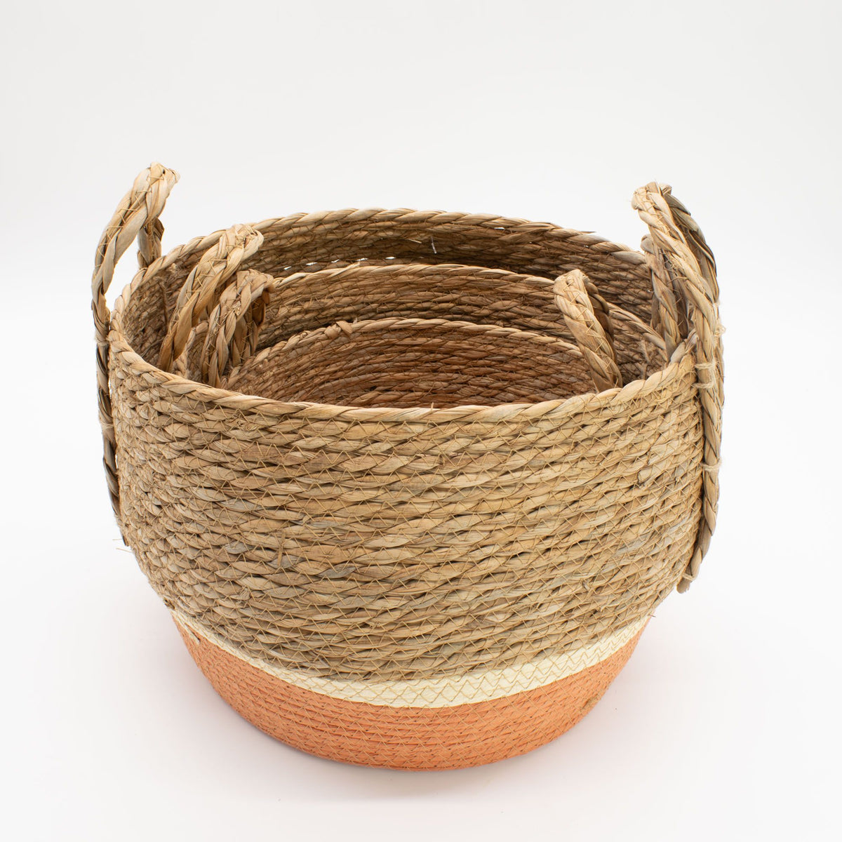 Nest of woven baskets with a natural rope design on a white background