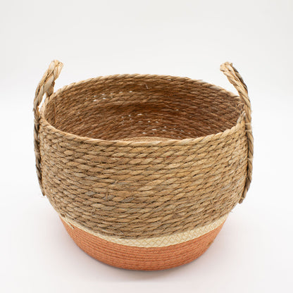 Woven basket with handles on a white background