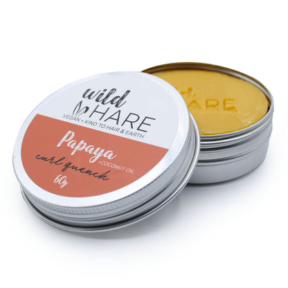 Papaya curl quencher solid shampoo bar by Wild Hare in a metal container on a white background