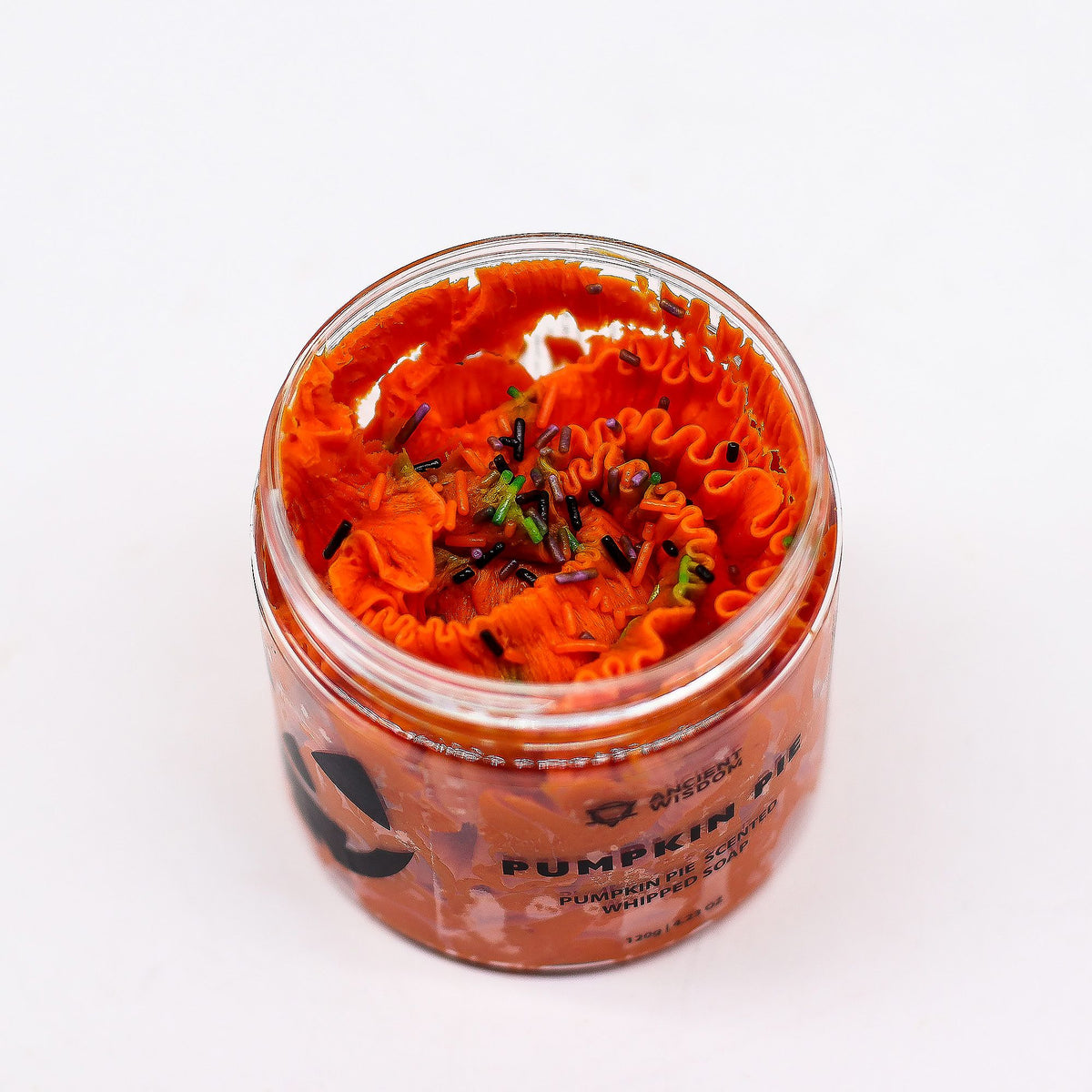 Jar of pumpkin spice soap on a white background
