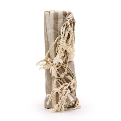 Beige towel with tassels on a white background