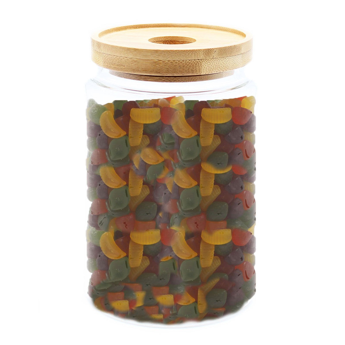 Jar of colorful gummy worms with a wooden lid on a white background