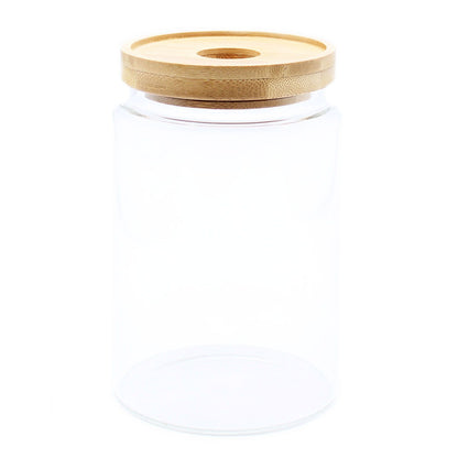 Clear glass jar with a wooden lid on a white background