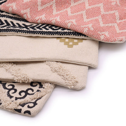 Stack of patterned cushion covers  on a white background