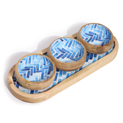 Set of three wooden bowls with blue geometric patterns on a matching wooden tray.