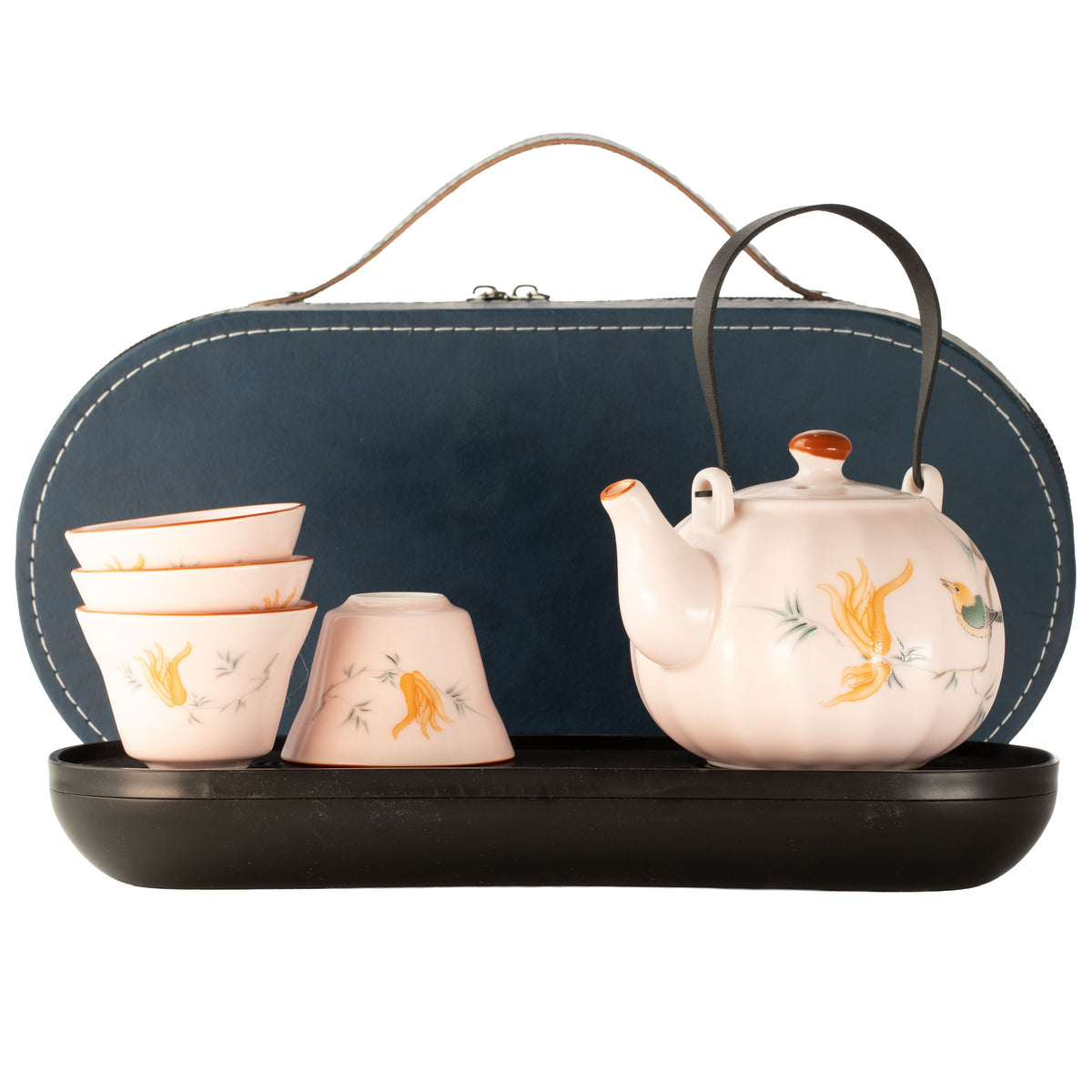 A ceramic tea set displayed on a black tray in front of a dark blue carrying case. The set includes a white teapot with yellow and green bird illustrations, a matching stack of four small cups, and a black lid.