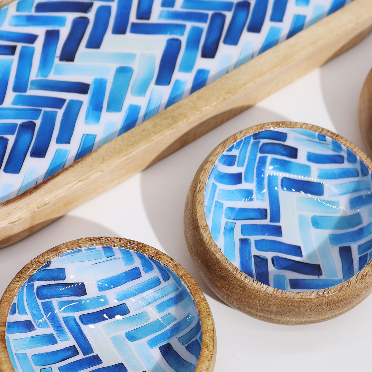 Wooden bowls with blue geometric pattern on a white background