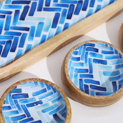 Wooden bowls with blue geometric pattern on a white background