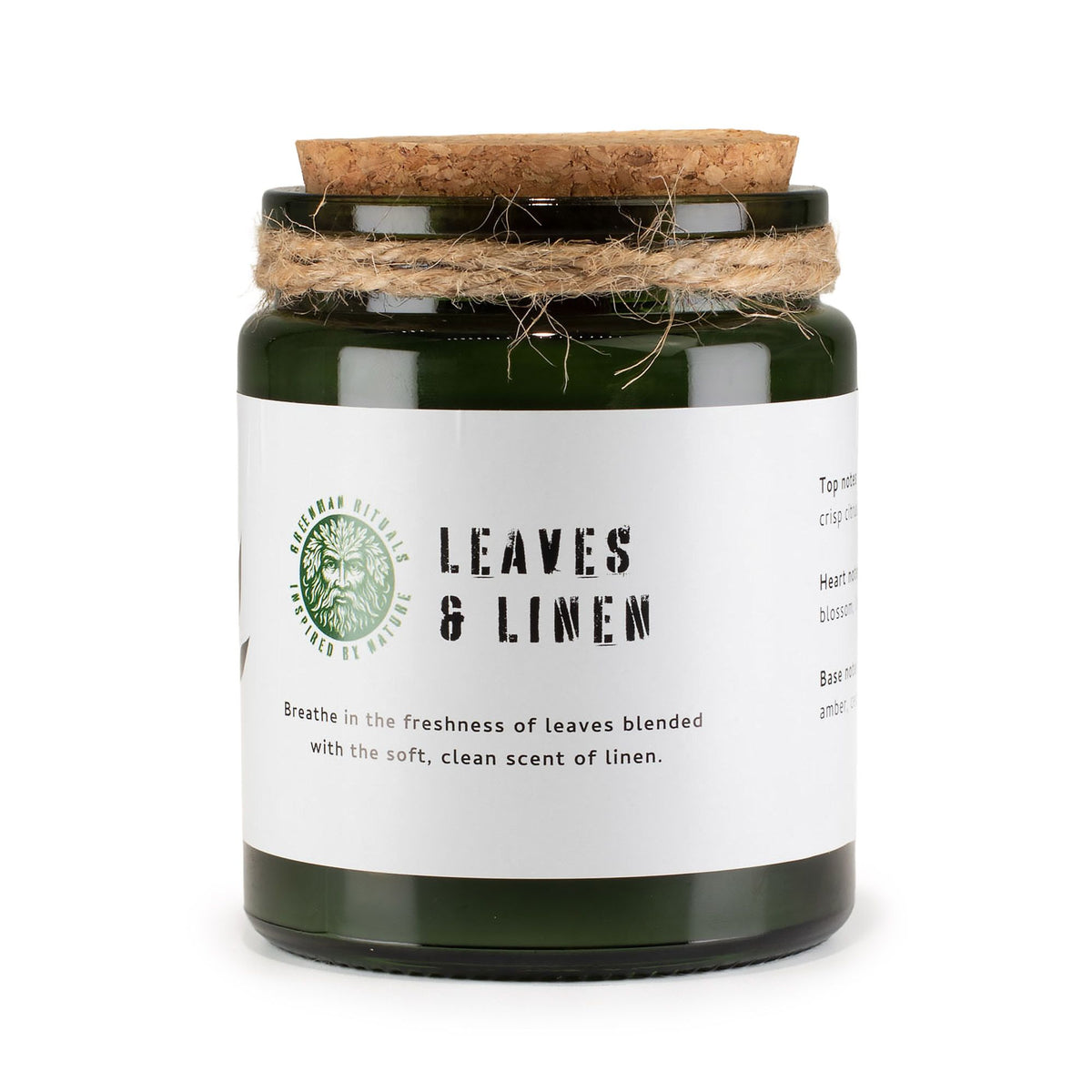 Candle jar labeled 'Leaves & Linen' with a cork lid on a white background