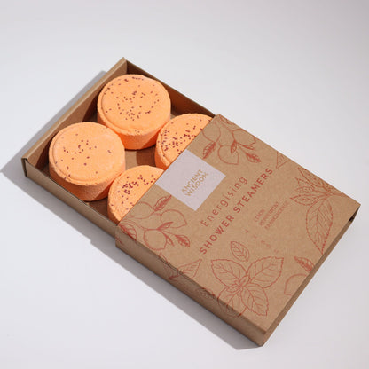 Box of Energising Shower Steamers with orange products on a white background