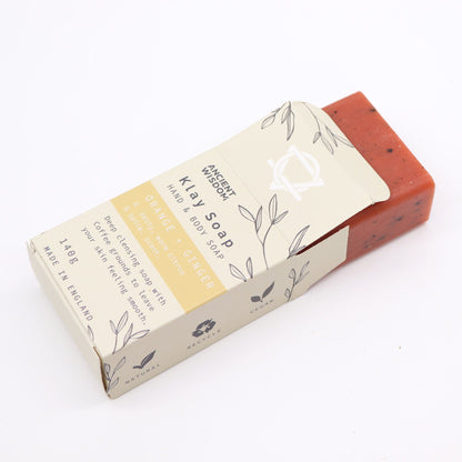 Bar of soap with a cardboard packaging on a white background
