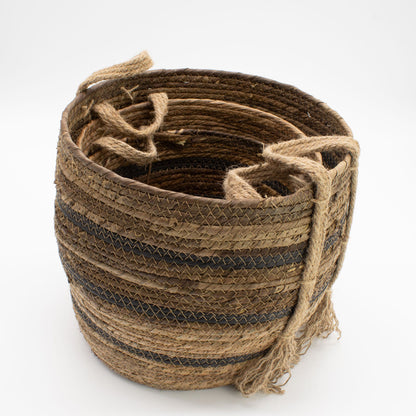 Nest of banana leaf seagrass baskets made of natural fibers on a white background