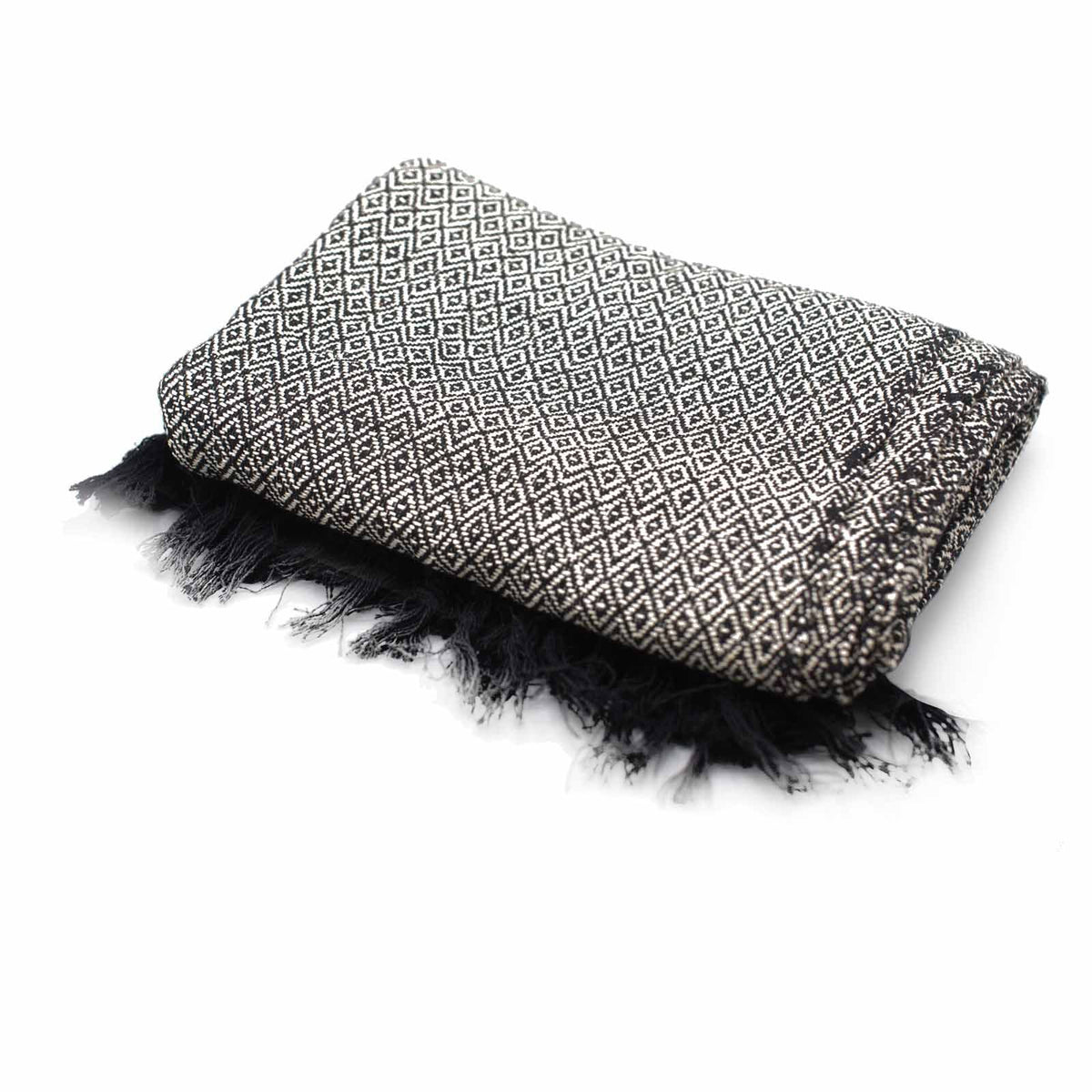 Folded blanket with geometric pattern and black fringes on a white background