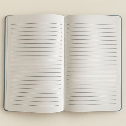 Open notebook with lined pages on a beige background