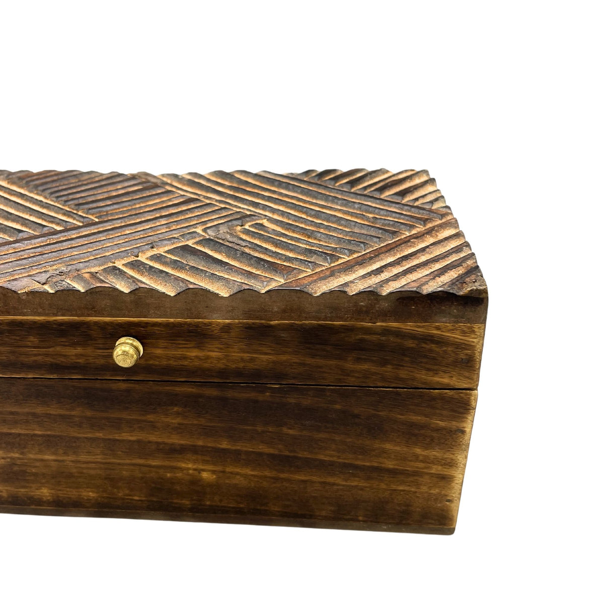 Wooden keepsake box with carved textured top and gold clasp on a white background