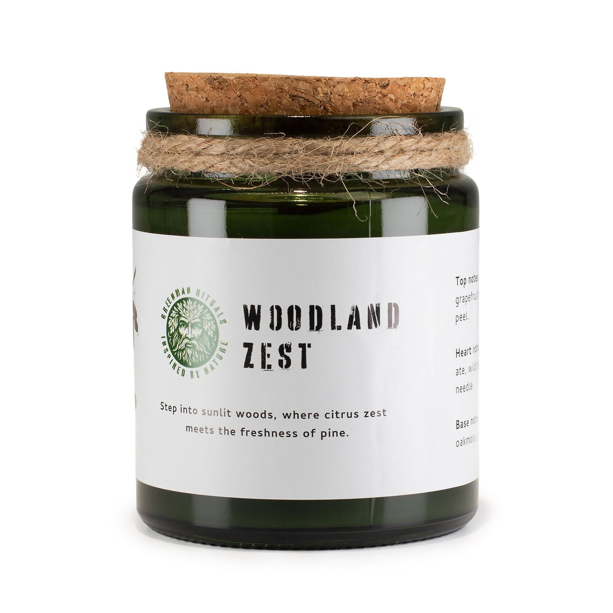 Candle jar labeled 'Woodland Zest' with a cork lid on a white background