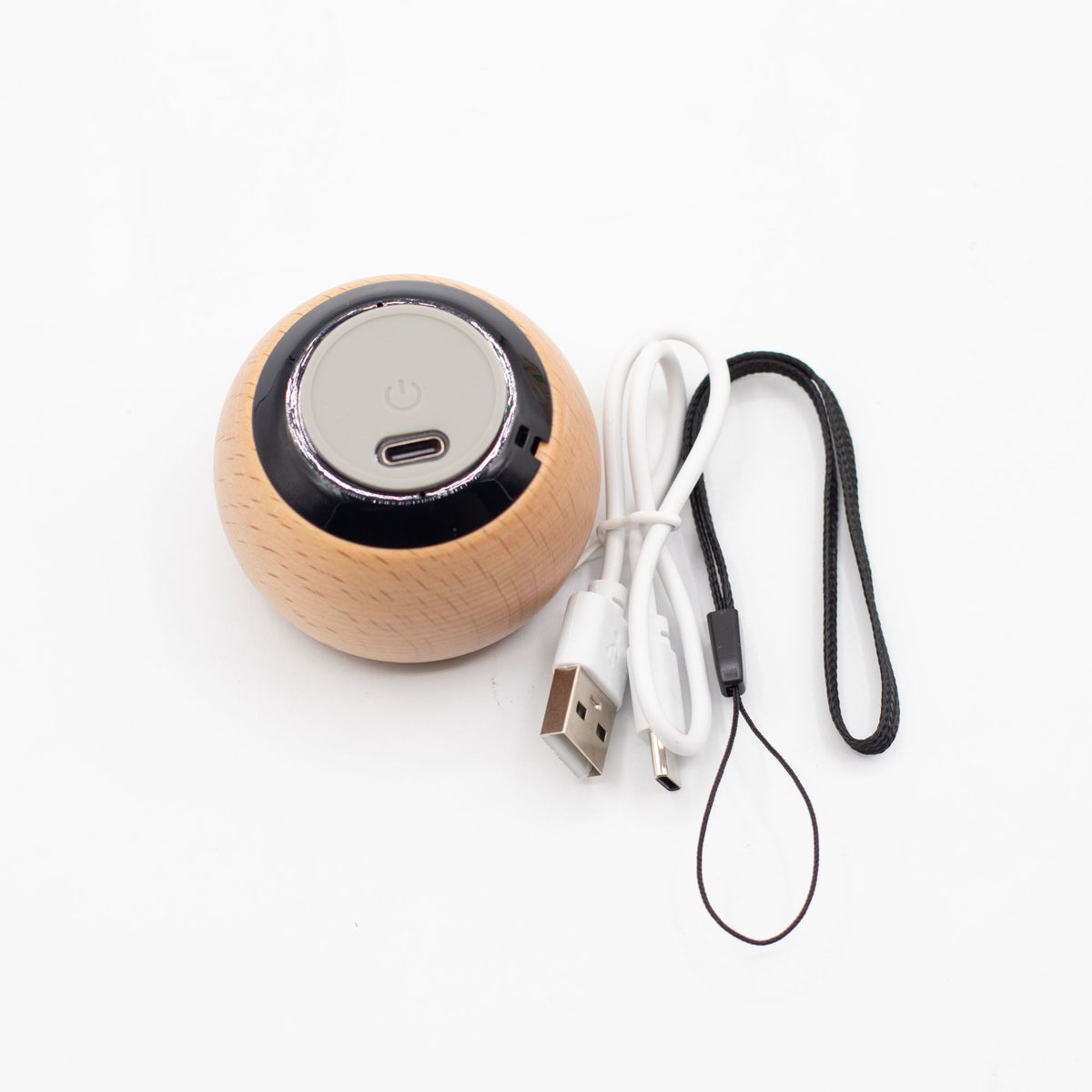 Wooden speaker with USB cable and lanyard on a white background