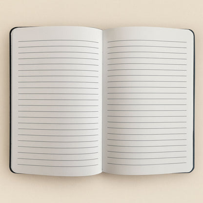 Open notebook with lined pages on a beige background