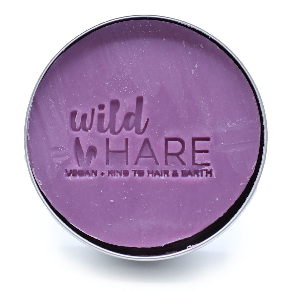Open container of purple 'wild HARE' Tutti Frutti Solid Shampoo Bar on a white background