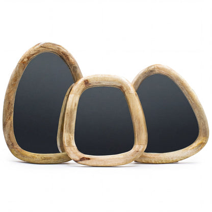 Three pebble shaped mirrors set with wooden frames on a white background