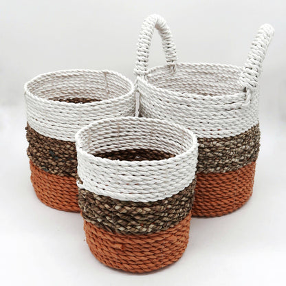 Three woven baskets with striped patterns on a white background