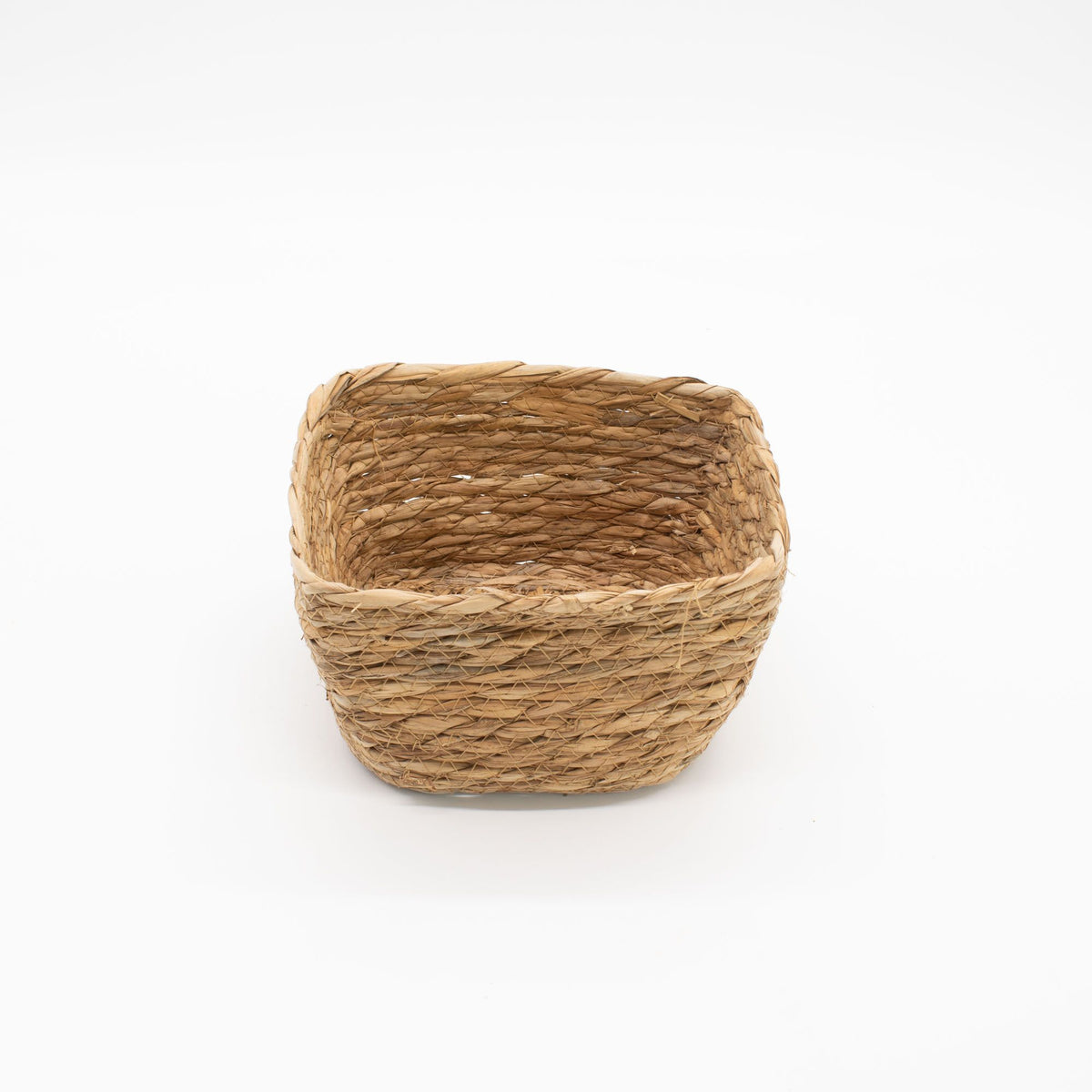 Woven basket made of natural fibers on a white background