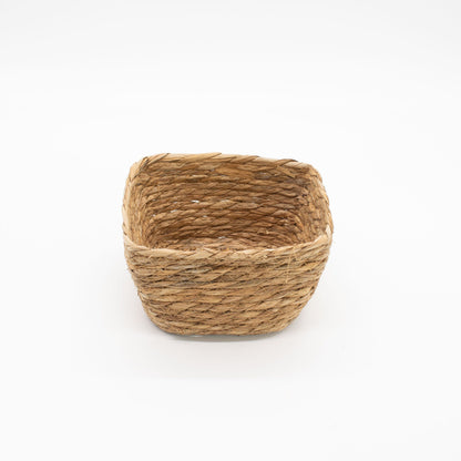 Woven basket made of natural fibers on a white background