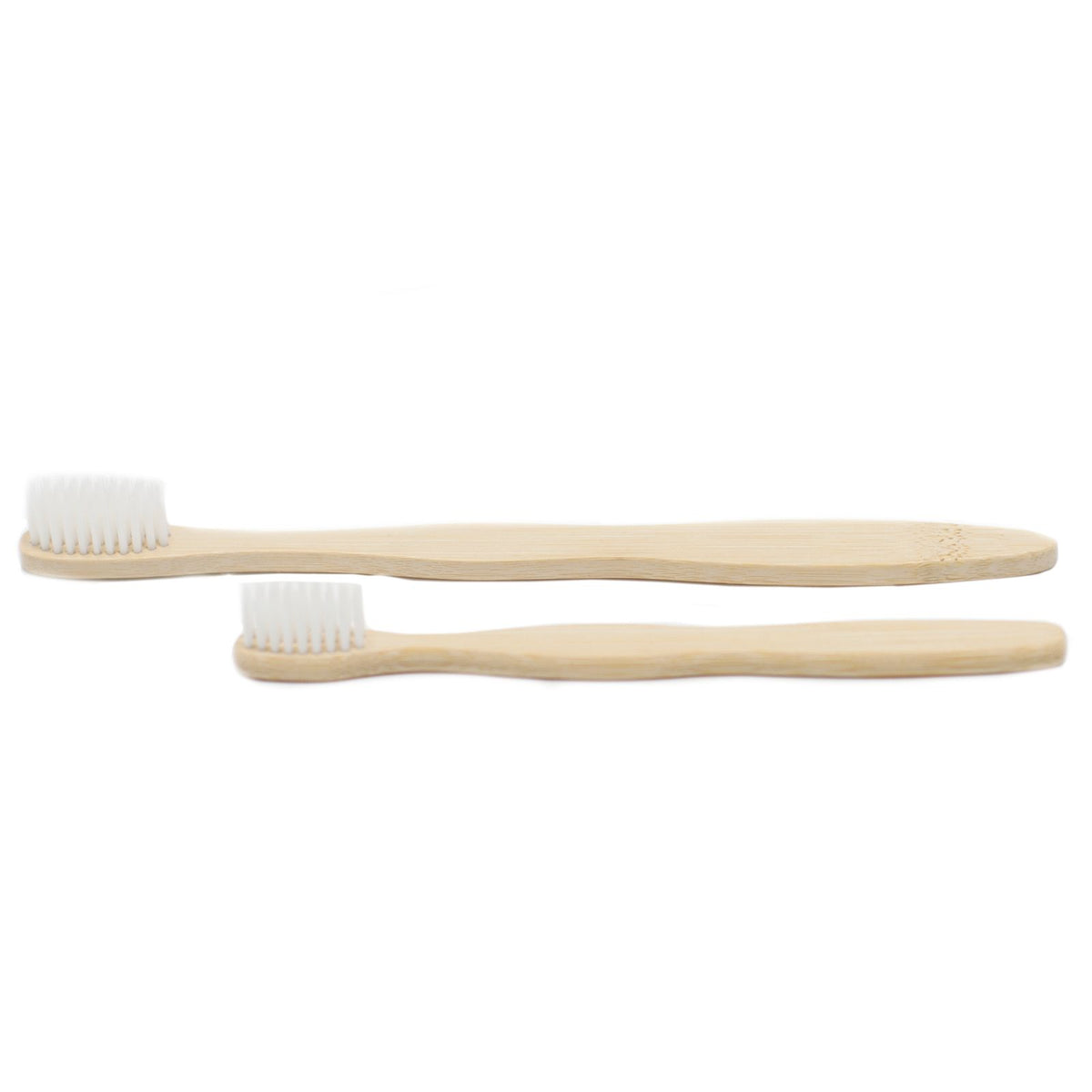 Two bamboo toothbrushes with white bristles on a white background