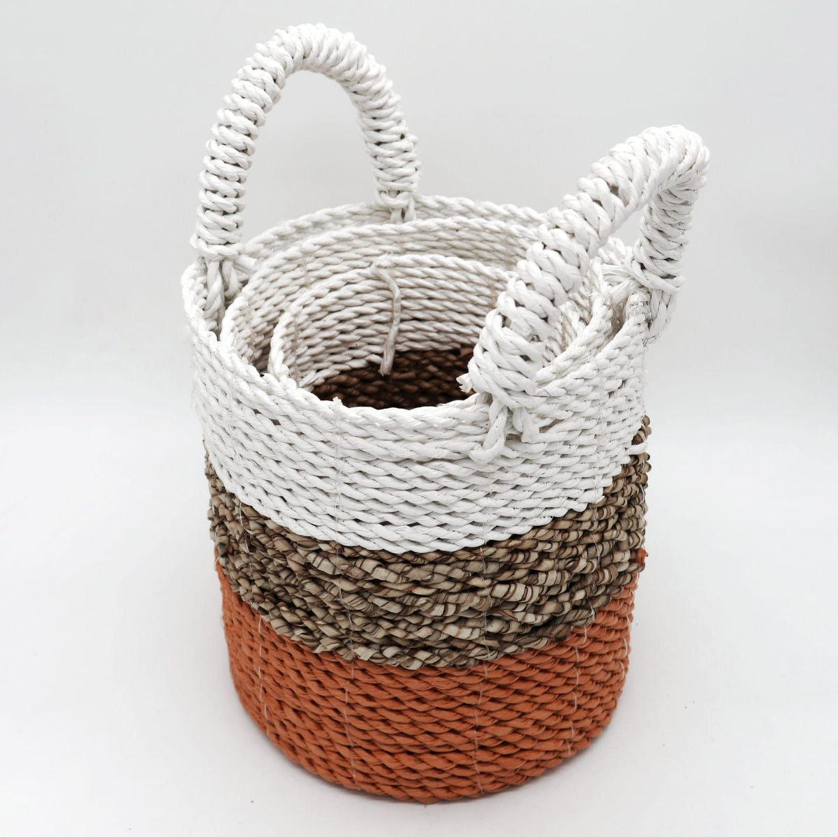 Woven basket with a gradient color pattern on a white background