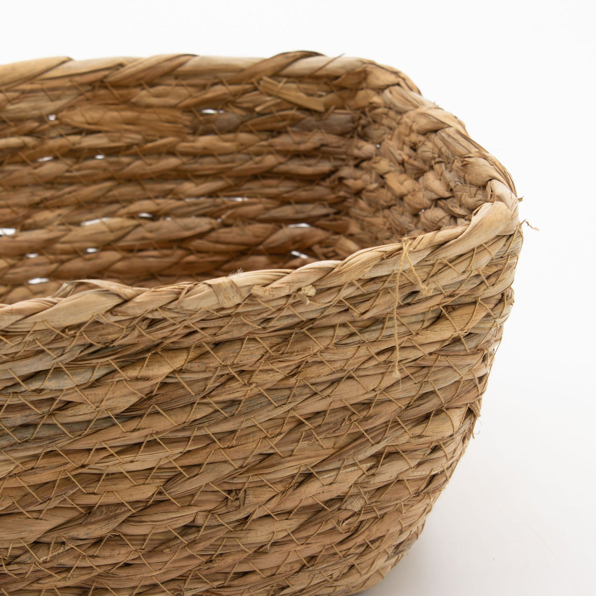 Close-up of a seagrass square basket with a white background