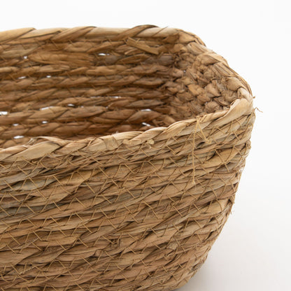 Close-up of a seagrass square basket with a white background