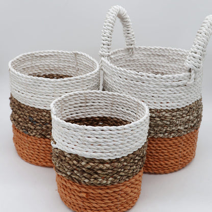Three woven baskets with striped pattern on a white background