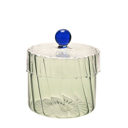 Green glass jar with blue lid on a white background